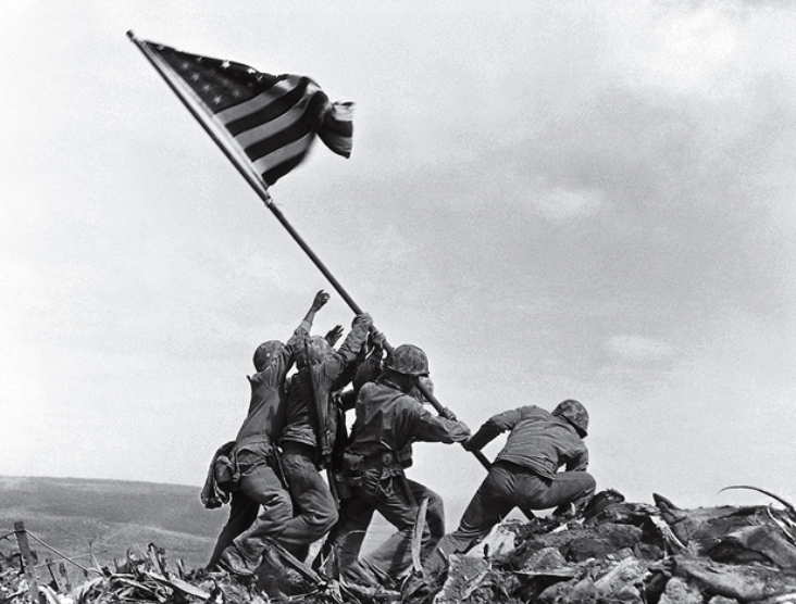 Iconic photograph of six United States Marines raising the U.S. flag atop Mount Suribachi during the Battle of Iwo Jima in the final stages of the Pacific War.